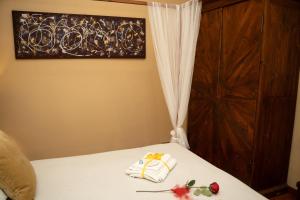 a bedroom with a bed with a curtain and flowers on it at Navona Apartment in Rome