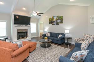 a living room with two couches and a fireplace at Quiet Family Home 15 Mi to Dtwn Huntsville! in Hazel Green