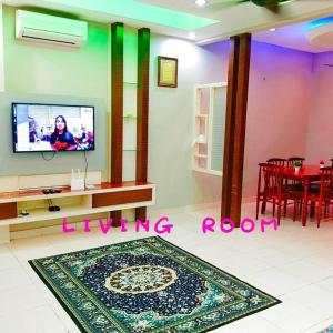 a living room with a tv and a living room at Muslim Suite Home @ Airport Bayan Lepas Penang in Bayan Lepas