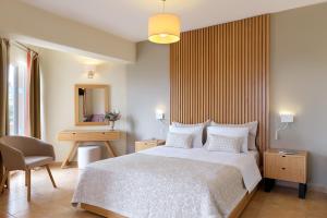 A bed or beds in a room at Aphrodite Hotel