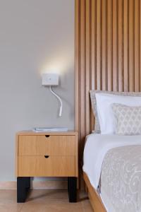 A bed or beds in a room at Aphrodite Hotel