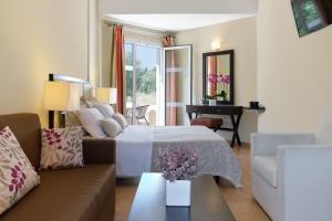 A bed or beds in a room at Aphrodite Hotel