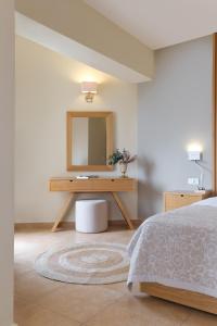 A bed or beds in a room at Aphrodite Hotel