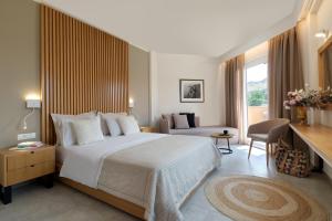 A bed or beds in a room at Aphrodite Hotel