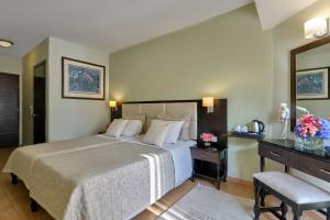 A bed or beds in a room at Aphrodite Hotel