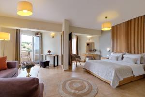 A bed or beds in a room at Aphrodite Hotel