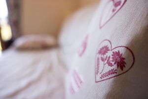 a close up of a bed with a heart on it at Gai Soleil in Saint-Gervais-les-Bains