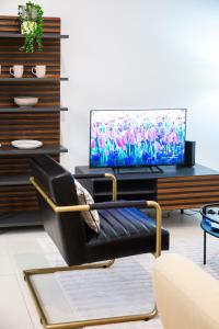 a black chair in a living room with a tv at Valletta Center Apartment in Valletta