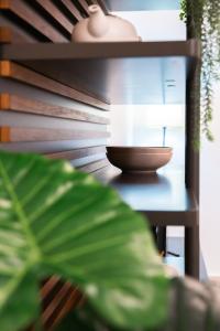 a bowl sitting on a table next to a plant at Valletta Center Apartment in Valletta