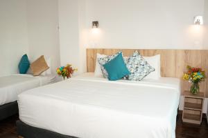 Postel nebo postele na pokoji v ubytování Hotel Caribbean Cartagena