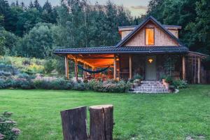 a house with a porch and a green yard at Domek Las Chill Us - w otoczeniu lasu i natury, przyjazny czworonogom - by Space Apart in Jelenia Góra