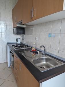 a kitchen with a sink and a stove at Vila Cabral 1 Bed Apt - Wi-Fi & Air Con Included in Sal Rei