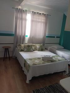 Cama ou camas em um quarto em Pousada Antares