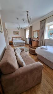 a living room with a couch and a bed at Bell Country Inn in Llanyre