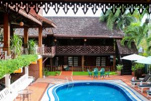 a house with a swimming pool in front of it at Chandara Boutique Hotel in Vientiane