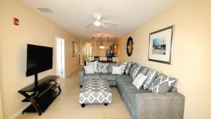 a living room with a couch and a flat screen tv at Johns Pass Condo's- Fully Remote in St. Pete Beach