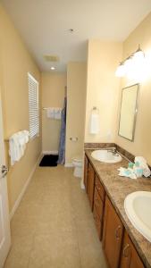 a bathroom with a sink and a toilet at Johns Pass Condo's- Fully Remote in St Pete Beach
