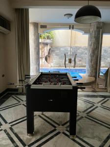 a pool table in the middle of a room at The GlassHouse Pool in Cairo