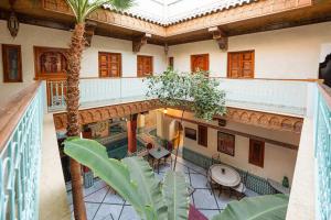 an overhead view of a building with a courtyard with palm trees at Riad Atlas Acacia in Marrakesh
