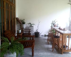 a room with chairs and a table with potted plants at Tranquil at Airport Reach in Gonawala