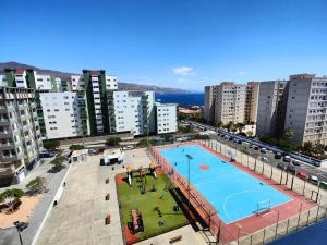 an aerial view of a swimming pool in a city at Vacacional Candelaria vistas al mar con garaje gratuito in Candelaria