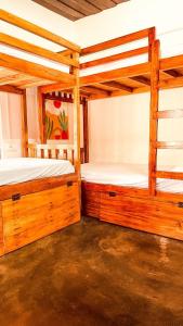 two bunk beds in a room with wooden floors at Zebra Hostels in Varkala