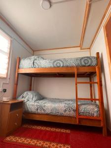 a bedroom with two bunk beds in a room at Hostal B&B Coastal Natales in Puerto Natales