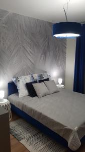 a bedroom with a large bed with a blue light at Domek dwupoziomowy pod Brzozami 4R in Chrzanów