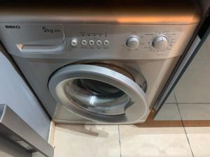 a washing machine in a room with at L'Odyssée, Appt 4 pers, parking privé, Wifi in Montpellier