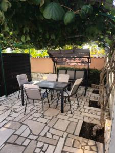 a table and chairs sitting on a patio at Apartments Vuceric in Peroj