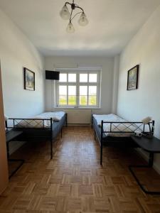 a room with two beds and a window at Sweet Home Inside Dresden Rooms in Dresden