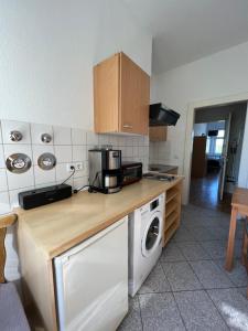 a kitchen with a washer and dryer on a counter at Sweet Home Inside Dresden Rooms in Dresden +6 photos