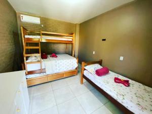 a bedroom with two bunk beds with red shoes on them at Rancho Santa Helena in Juazeiro