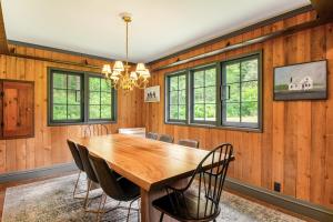 a dining room with a wooden table and chairs at Bayleaf Cottage in Madrona Beach