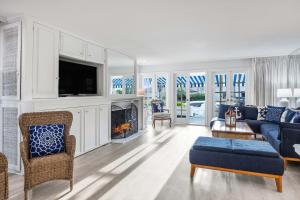 a living room with a couch and a tv at By The Sea in San Diego