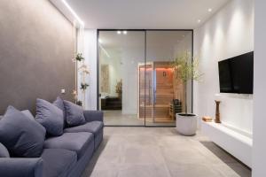 a living room with a couch and a tv at Nest House & Relax in Civitanova Marche