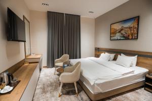 a hotel room with a bed and a tv at PREMIER HOTEL in Andijan