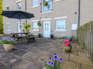 a patio with a picnic table and an umbrella at 4 Alpha Rise in Brampton