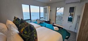 a bedroom with a bed with a view of the ocean at Copper Beach Villa 1 Umdloti in Umdloti