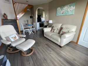a living room with a couch and a chair at Hillside View, Inverness in Inverness