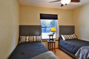 a bedroom with two beds and a window at Executive Hills in Las Cruces