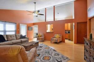 a living room with a couch and a ceiling fan at Executive Hills in Las Cruces