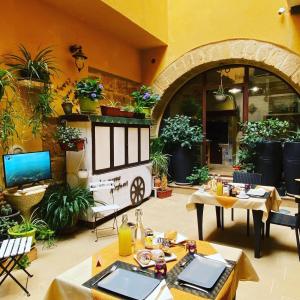 a patio with tables and chairs and potted plants at La Nuova Girgenti in Agrigento
