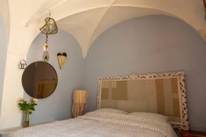 a bedroom with a large bed and a mirror at la casa degli Archi in Pesaro