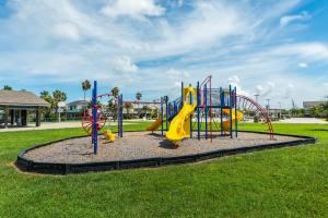 a playground with a slide in a park at Paradise Perch in Galveston