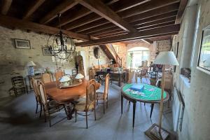 a dining room with a wooden table and chairs at Rare pearl with garden near the sea in La Baule