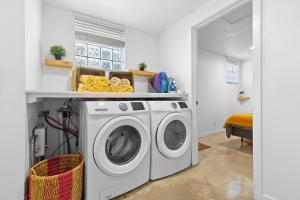 a white laundry room with a washer and dryer at Farmhouse style Home- near Hollywood Beach/ Hot Tub! in Hollywood