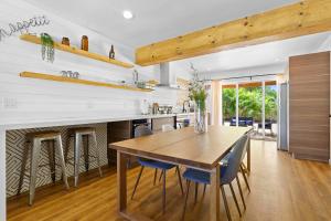 a kitchen and dining room with a wooden table and chairs at Farmhouse style Home- near Hollywood Beach/ Hot Tub! in Hollywood