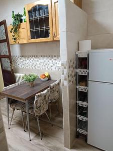 a kitchen with a table with chairs and a refrigerator at León Antiguo Palomera in León
