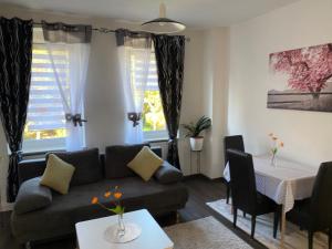 a living room with a couch and a table at Ferienwohnung Pension Sofia 2 in Meißen